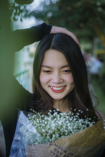 Smiling Woman Holding Flowerss