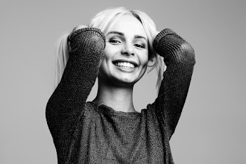 Smiling Woman Holding Hair on  Both Hands