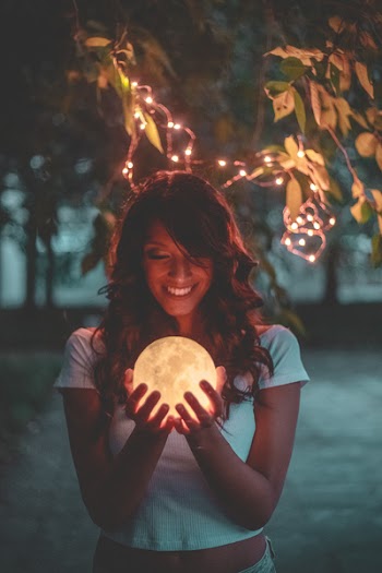 Smiling Woman Holding Moon