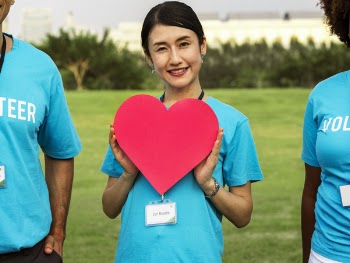 Smiling Woman Holding Red Cutout Heart