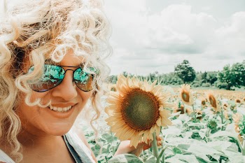 Smiling Woman Holding Sunflower