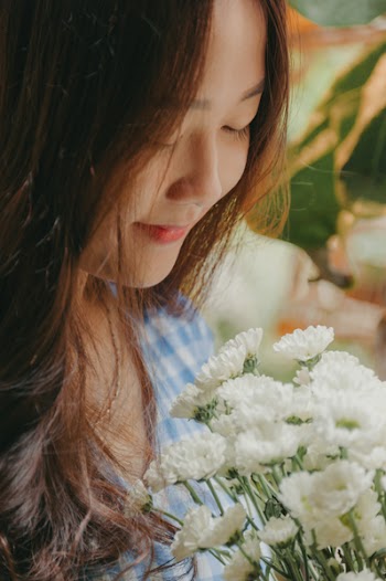 Smiling Woman Holding White Mums Flower Bouquet
