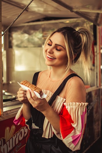 Smiling Woman Holds Cake With Both Hands