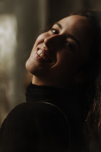 Smiling Woman in Black Turtleneck Top on Selective Focus Photography