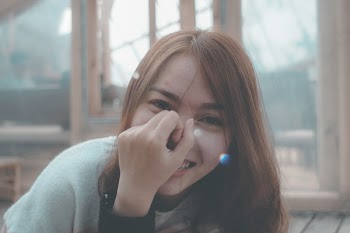 Smiling Woman in Gray Top