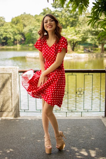 Smiling Woman in Red and White Polka-dot Dress