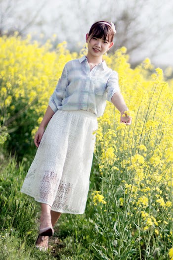 Smiling Woman in White and Blue Dress