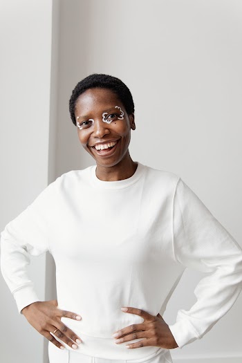 Smiling Woman in White Long Sleeve Shirt · Free Stock Photo