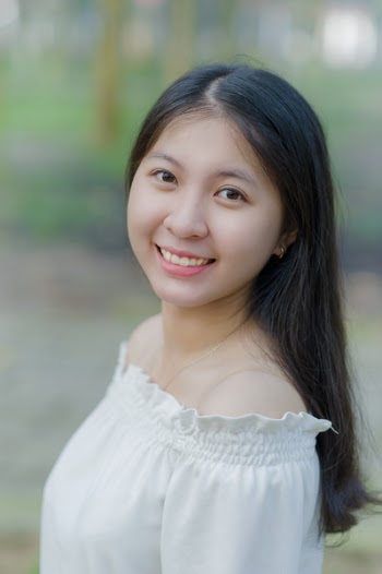 Smiling Woman in White Off-shoulder Tops