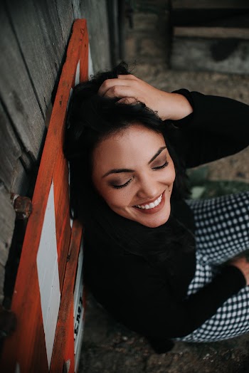 Smiling Woman Lean on Wall
