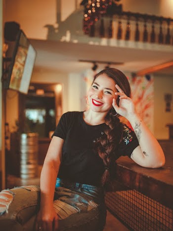 Smiling Woman Leaning at the Table