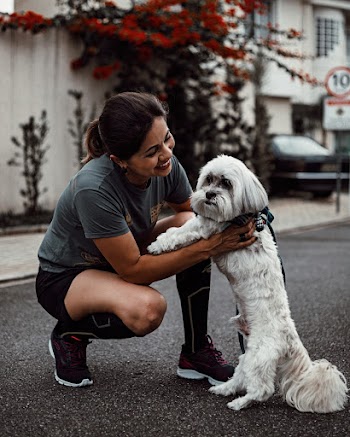 Smiling Woman Petting White Dog 