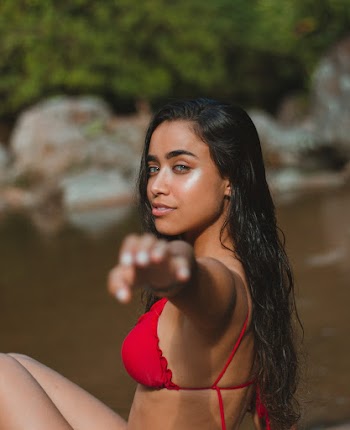 Smiling Woman Sitting Near Body of Water