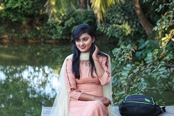 Smiling Woman Sitting On Bench Near River