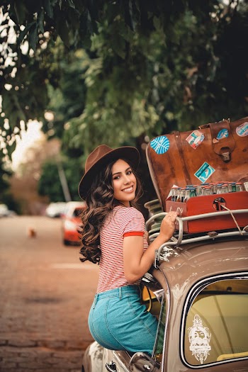 Smiling Woman Sitting on Car Window