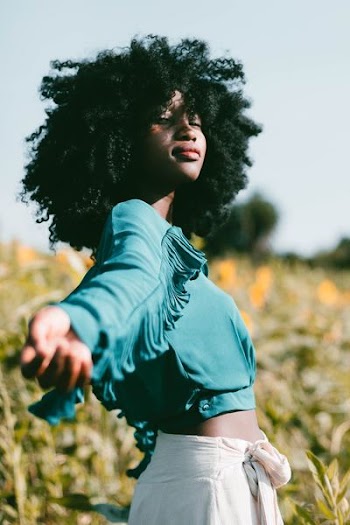 smiling woman spearing her arm during daytime