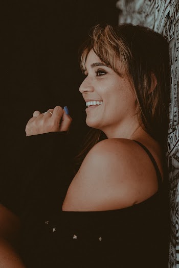 Smiling Woman Standing Against the Wall
