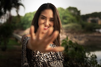Smiling Woman Standing and Showing Her Right Hand