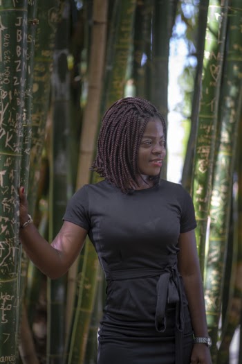 Smiling Woman Standing Near Bamboo Trees