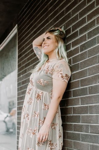 smiling woman standing near wall