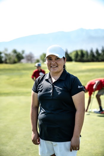 Smiling Woman Standing on Golf Course