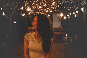 Smiling Woman Under String Lights