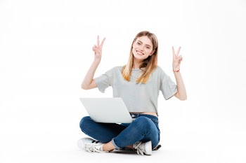 Smiling woman using laptop computer Free Photo