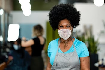 Smiling woman wearing a mask during the new… | Free stock photo | High Resolution image