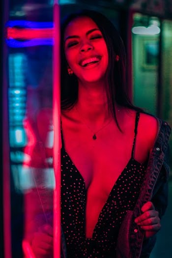 smiling woman wearing black polka-dot top