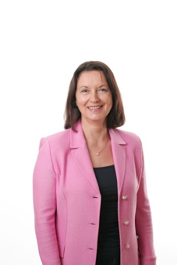 Smiling Woman Wearing Black Shirt and Pink Button Up Blazer