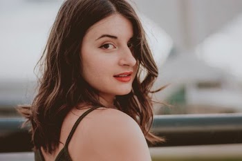 smiling woman wearing black sleeveless top
