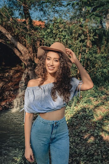 Smiling Woman Wearing Blue Crop Top