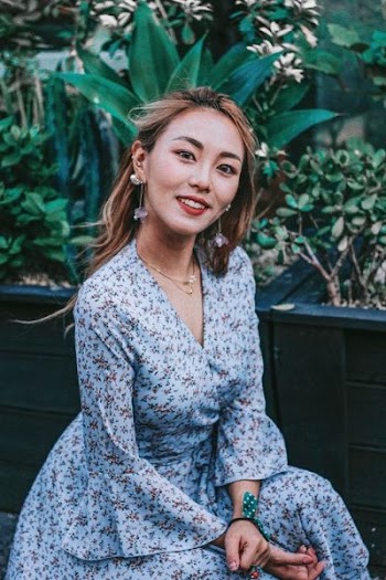 smiling woman wearing blue floral blazer