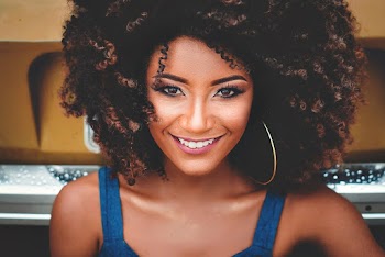 Smiling Woman Wearing Blue Sleeveless Top
