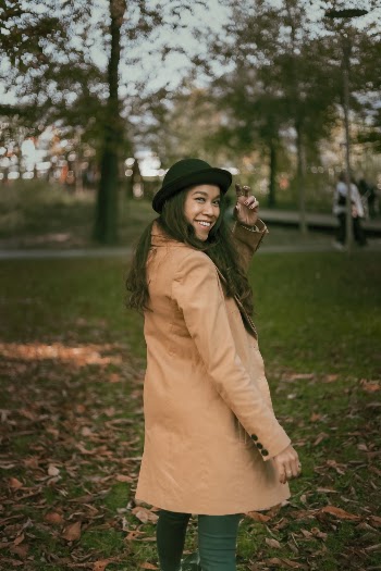 Smiling Woman Wearing Brown Coat