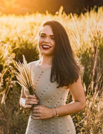Smiling Woman Wearing Brown Sleeveless Dress