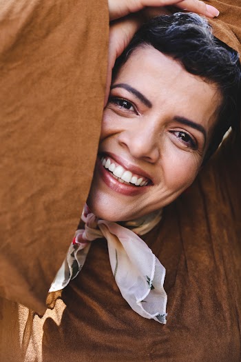 Smiling Woman Wearing Brown Top