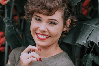 Smiling Woman Wearing Gray Crew-neck Cap-sleeved Shirt