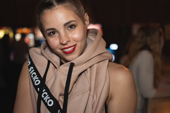 Smiling Woman Wearing Hooded Vest