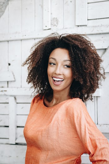 Smiling Woman Wearing Orange Crew-neck Top 