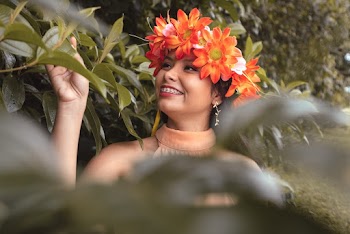 Smiling Woman Wearing Orange Floral Headdress