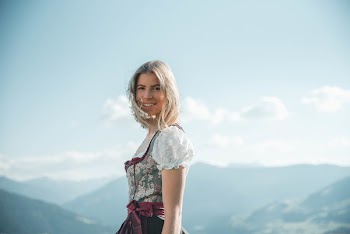 Smiling Woman Wearing White And Green Floral Cuff-shoulder Dress