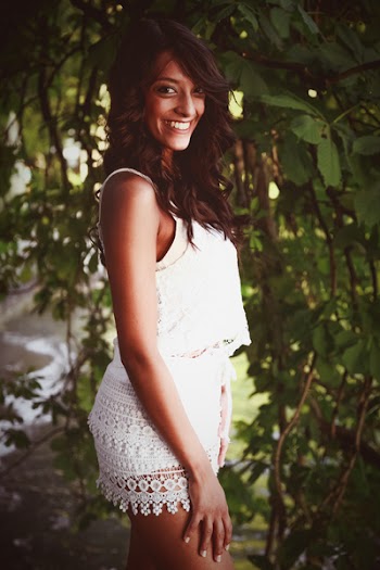 Smiling Woman Wearing White Camisole And White Bottoms