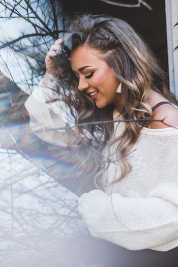 smiling woman wearing white sweater