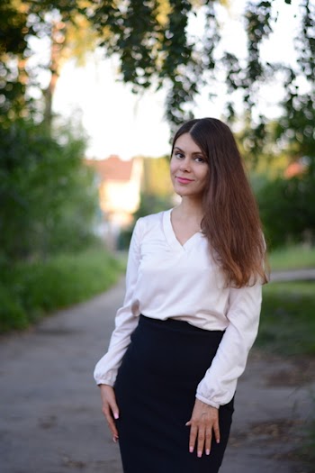 Smiling Woman Wearing White V-neck Long-sleeved Shirt And Black Bottoms