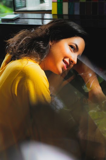 Smiling Woman While Leaning On Glass