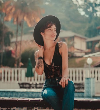 Smiling Woman While Sitting on Bench