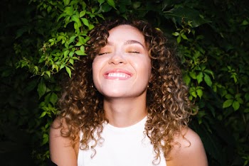 Smiling Woman With Curly Hair