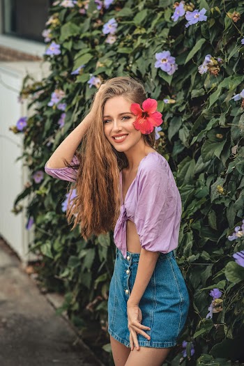 Smiling Woman With Red Hibiscus on Ear