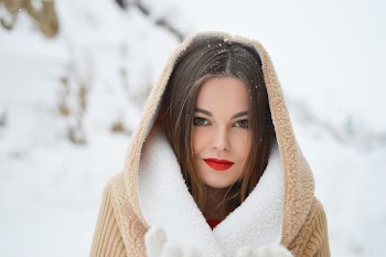 smiling woman with winter coat during daytime